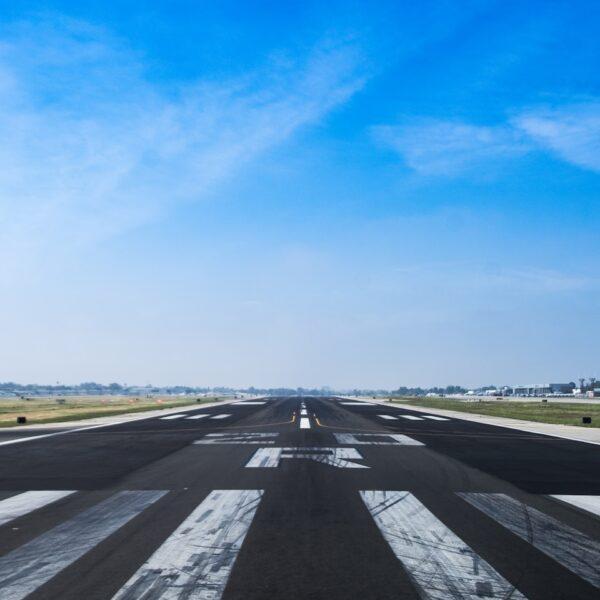 airplane road under cumulus clouds